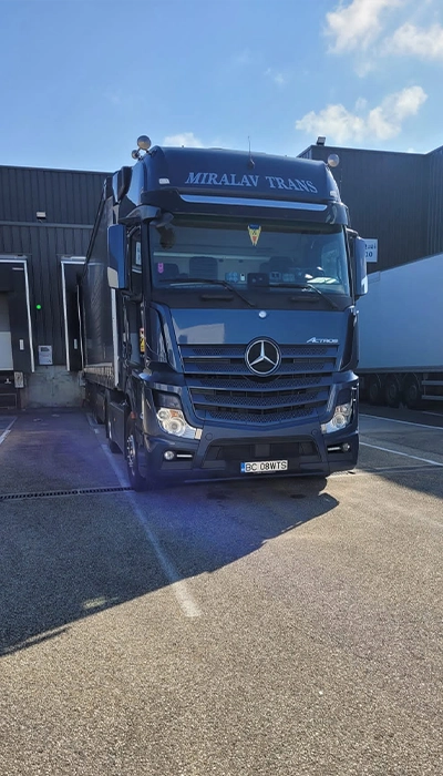Ansamblu camion Mercedes-Benz si semi-remorca cu prelata fotografiate in rampa pentru a fi incarcate cu marfuri